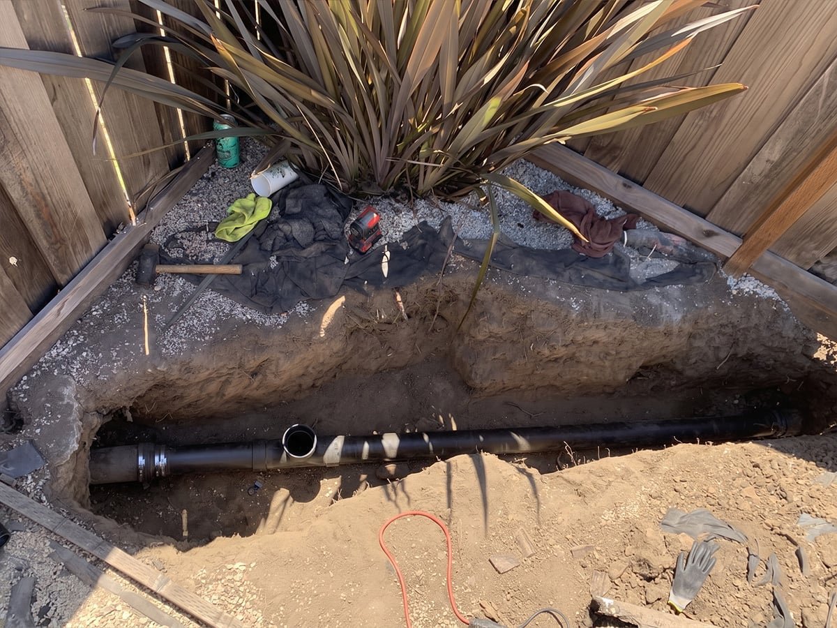 New ABS sewer pipe with no-hub coupling in an open trench