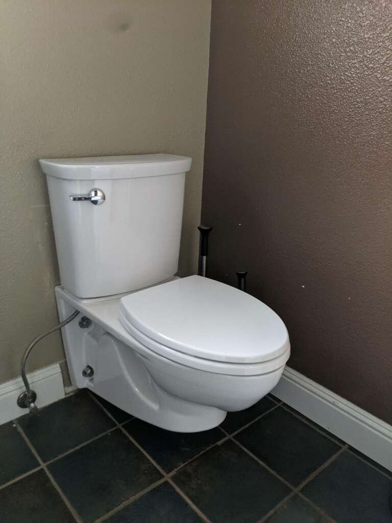 New two-piece toilet installed on a tile floor