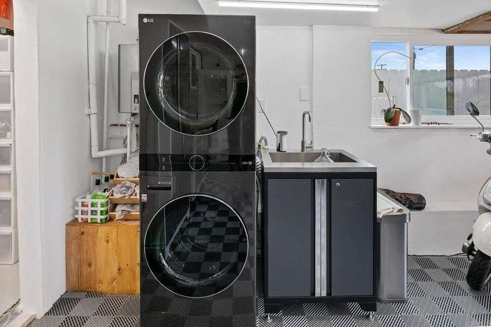 Finished laundry room with utility sink and washer hookups