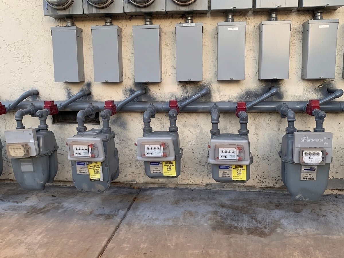 Row of gas meters with new gas piping and seismic valves