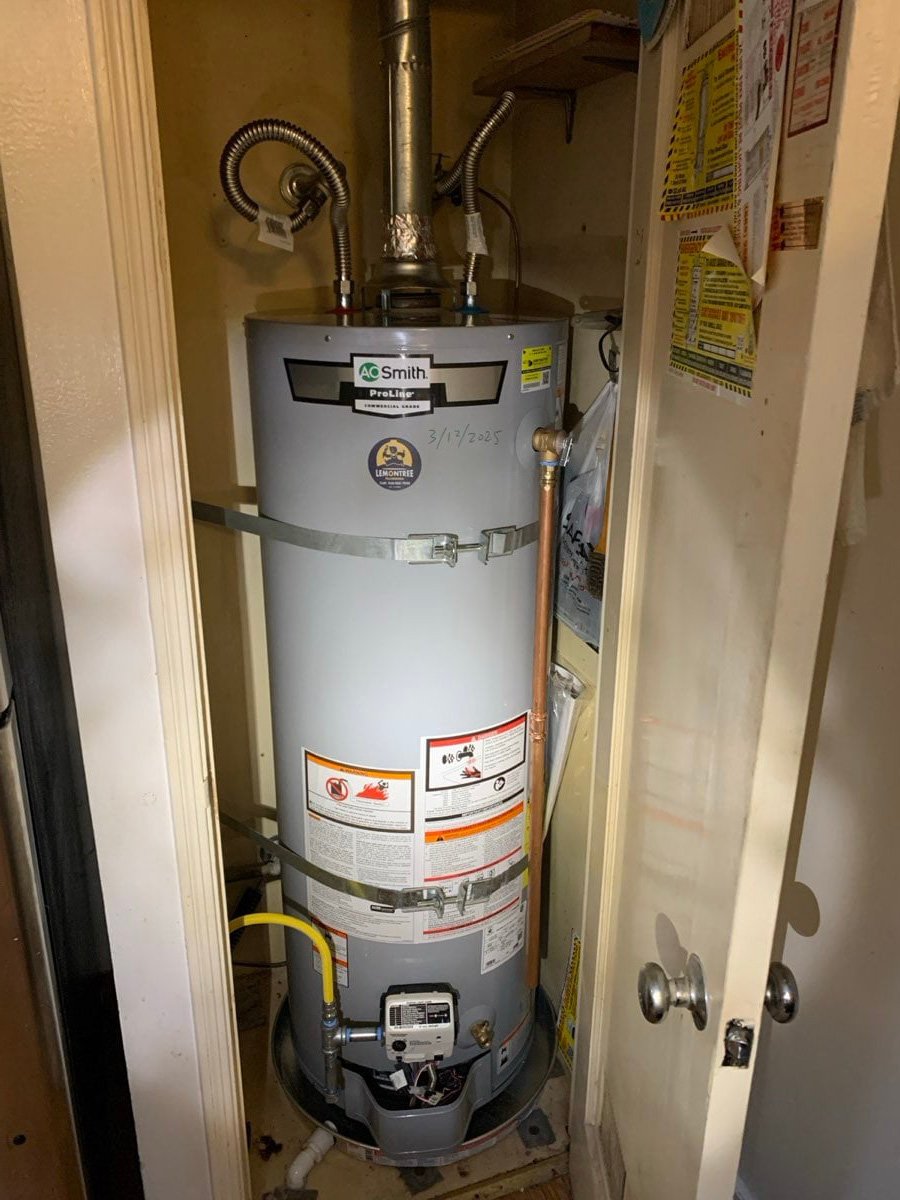 Tank water heater installed in a closet with seismic straps