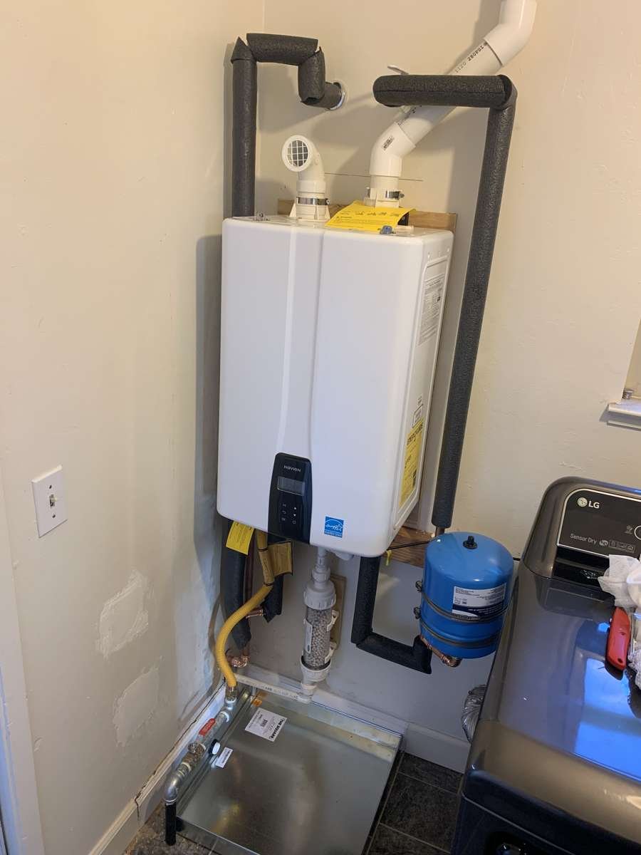 Tankless heater in a laundry closet with expansion tank and filter