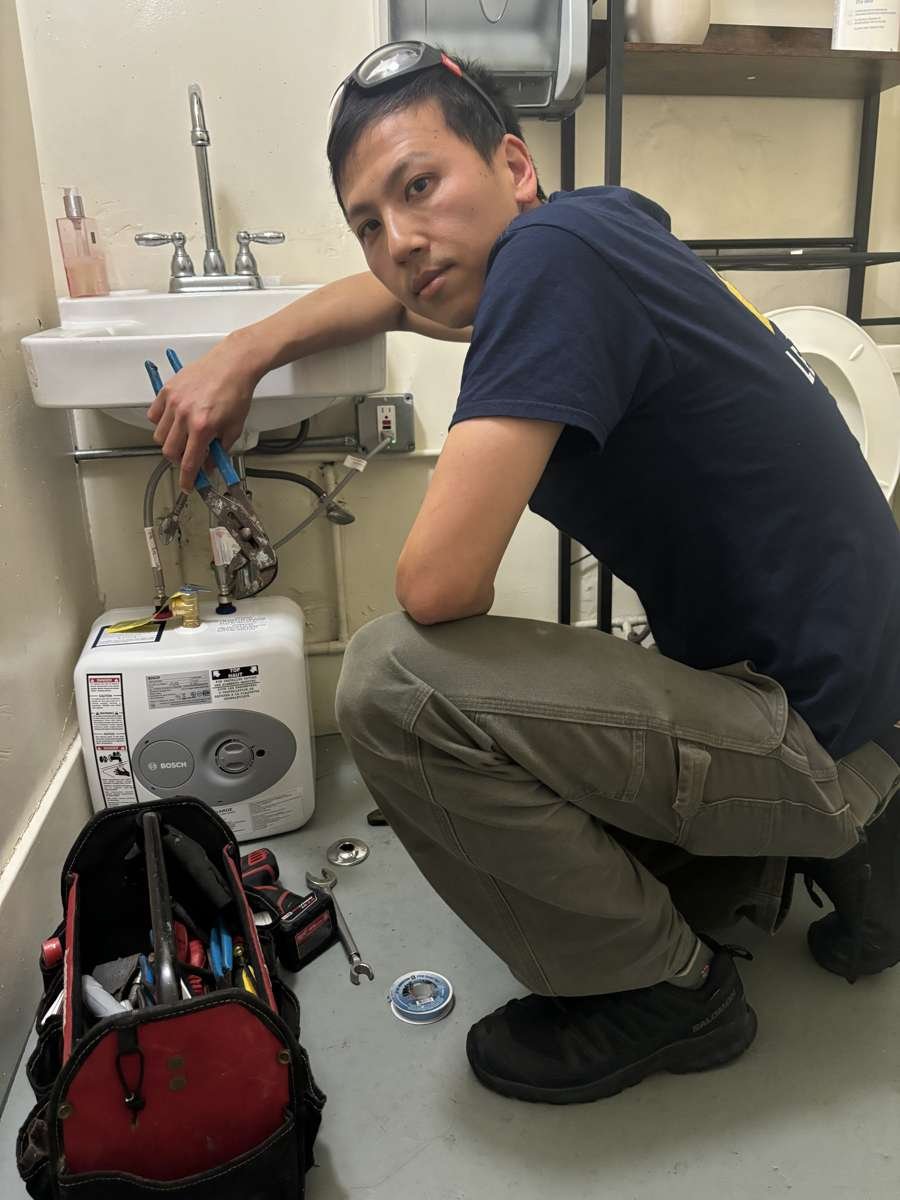 Point-of-use mini electric water heater installed under a sink