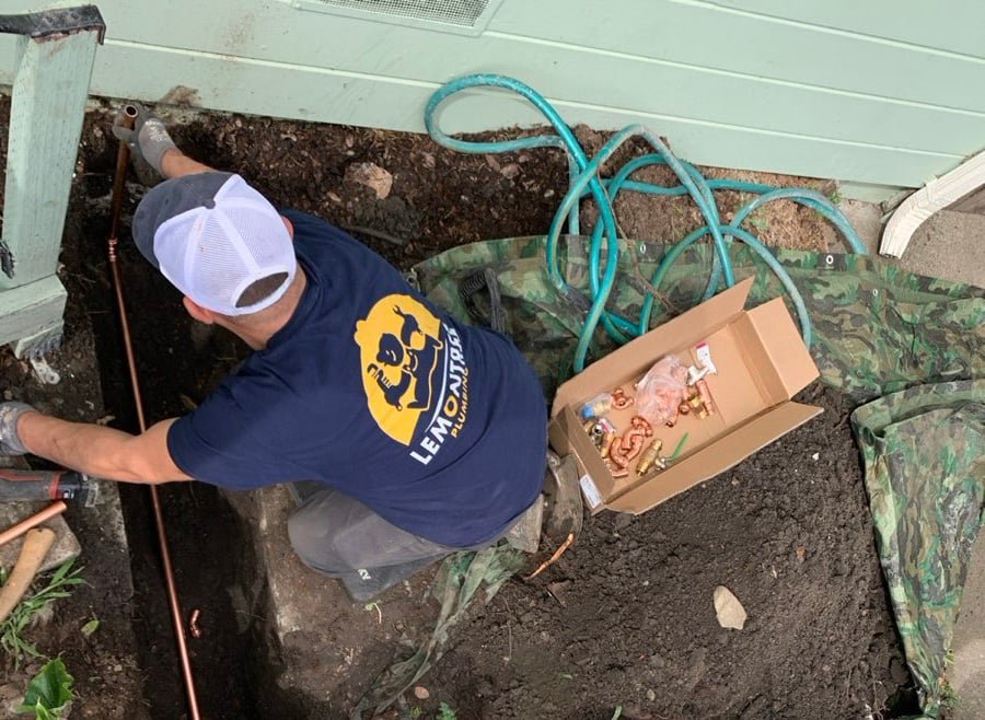 Technician installing a new copper main water line
