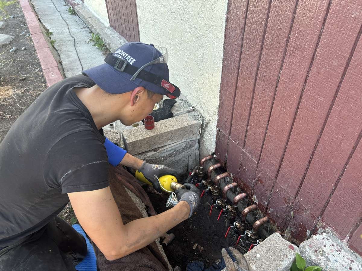 Technician sweating copper stub-outs during a repipe