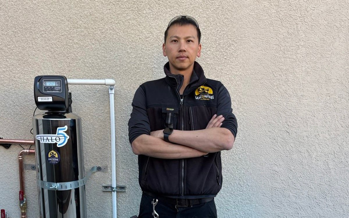 Technician with a newly installed whole-house water filtration system