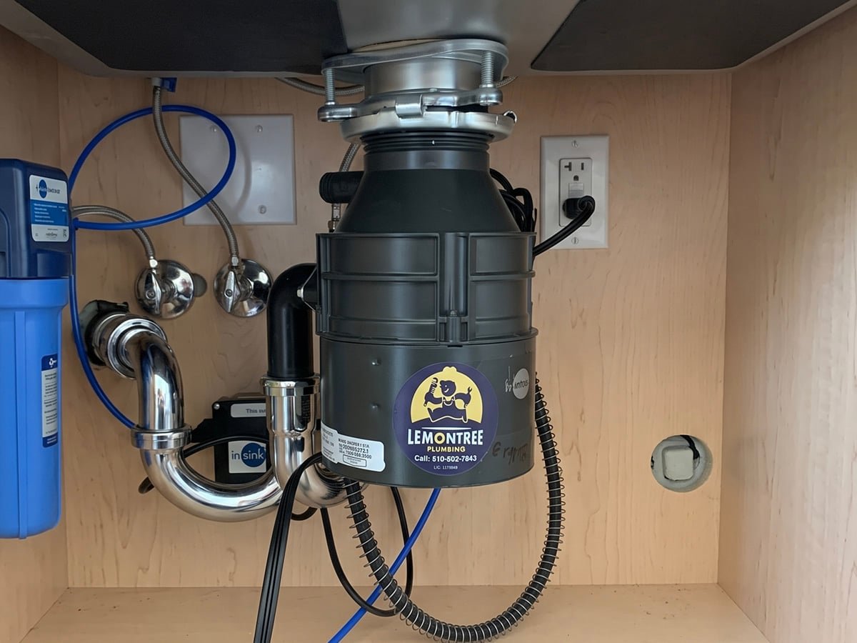 New garbage disposal under a kitchen sink