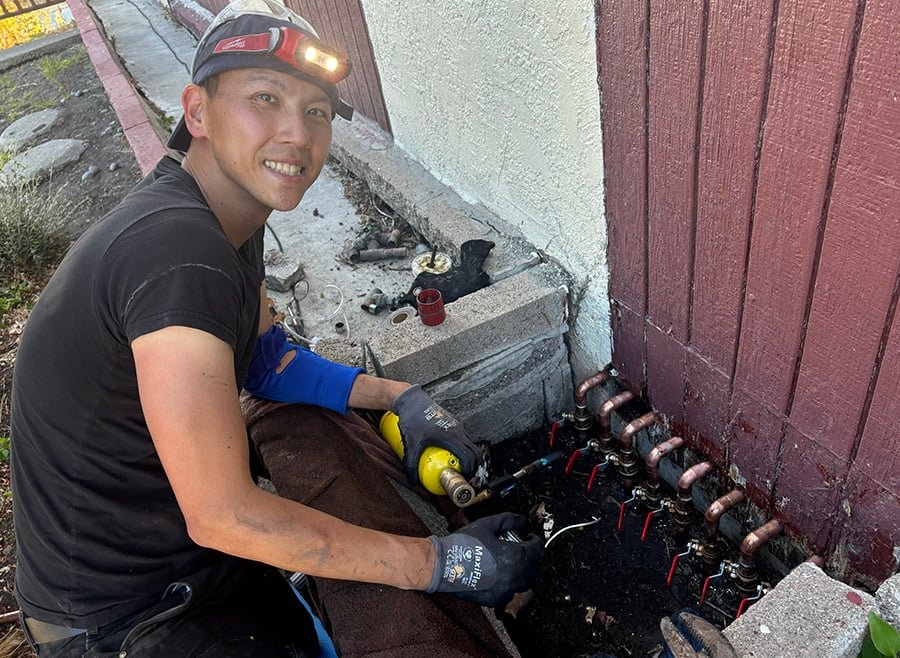 Technician installing a new copper main water line